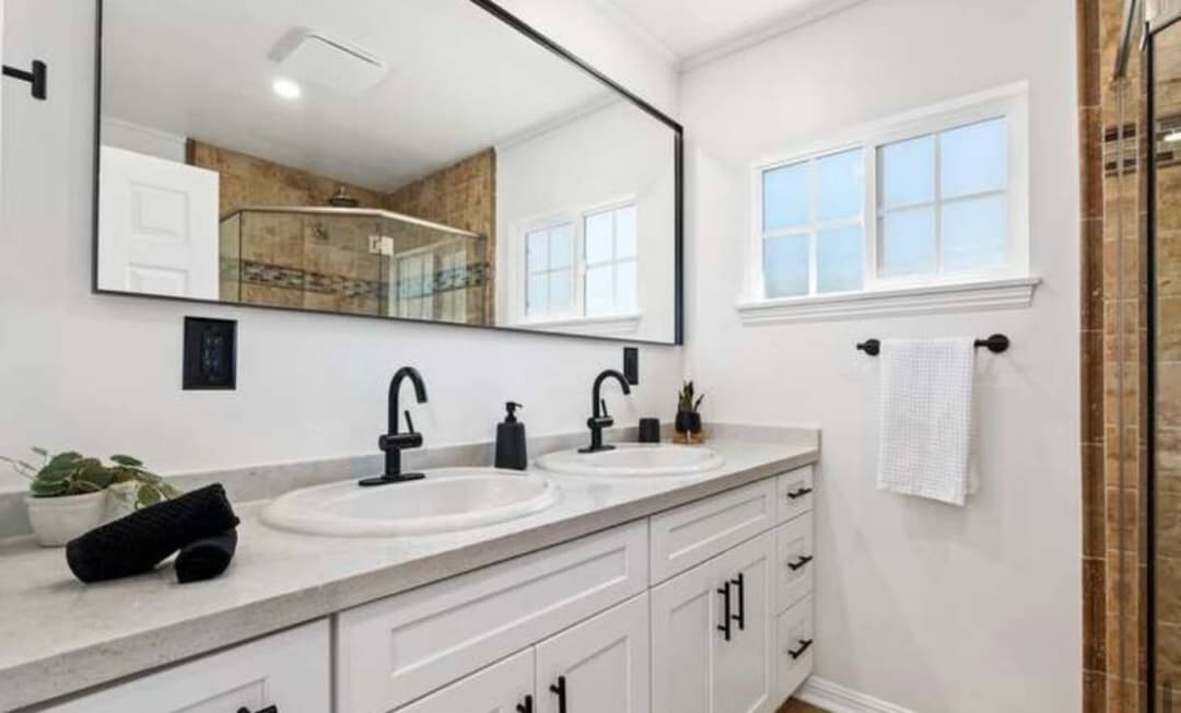 picture of a luxury remodeled bathroom dual sink with luxury cabinets and custom faucets and fixtures