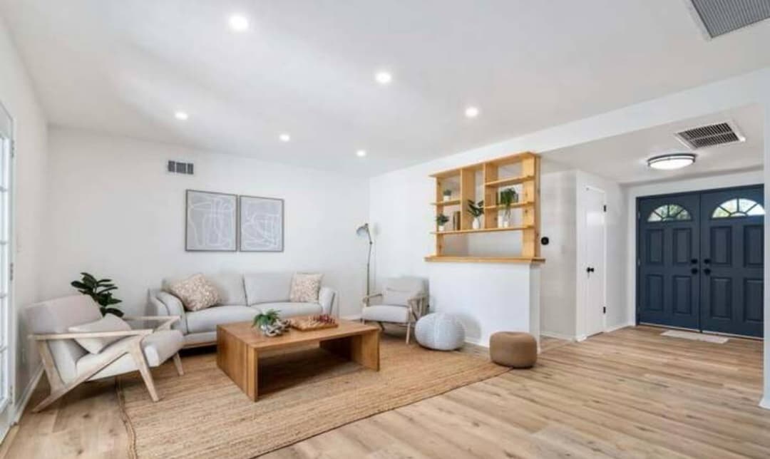 picture of newly remodeled living room with installed ceiling lights and wood floors