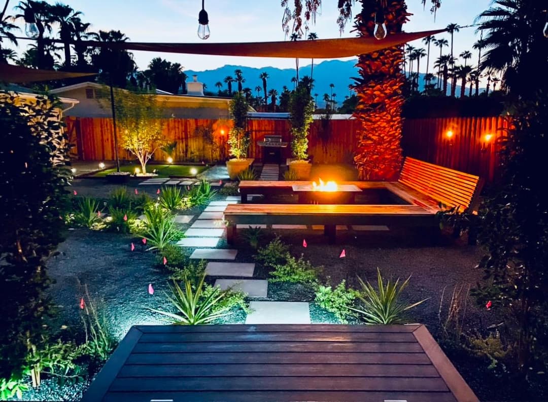 picture of beautifully designed and remodeled backyard with plants and lounge area with custom lighting designed by Blue Ladder Designs