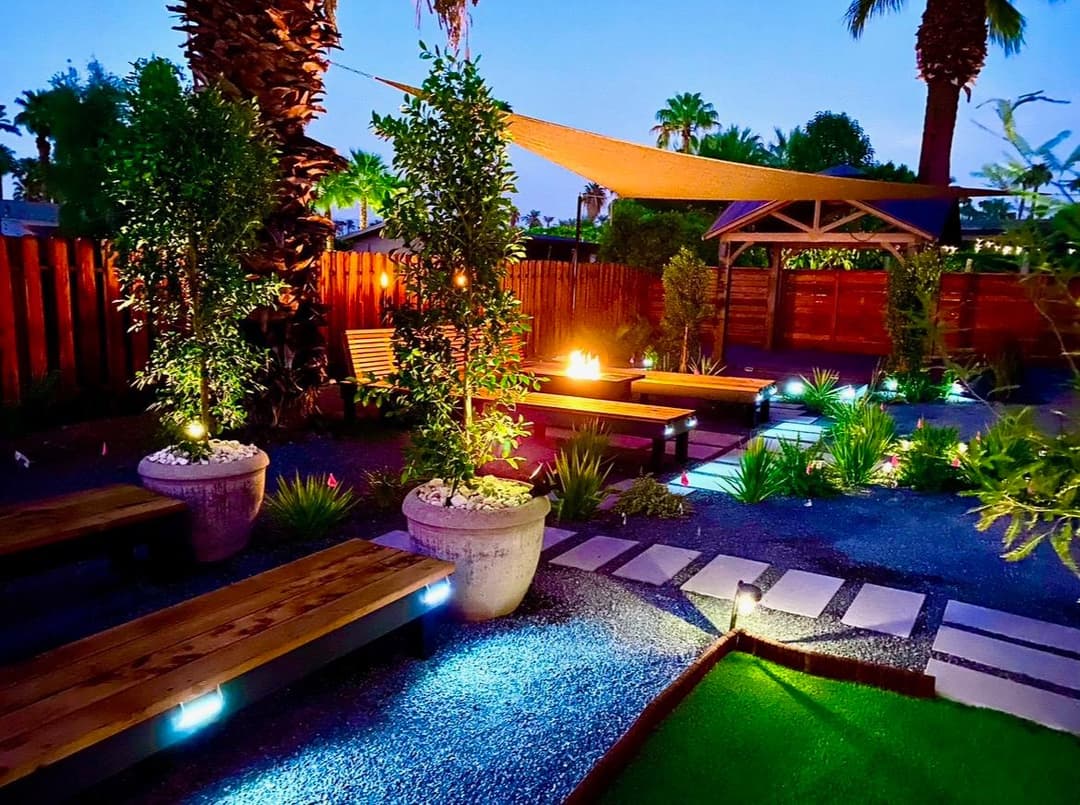 picture of a beautifully designed and remodeled backyard with custom plants, benches, and shrubs